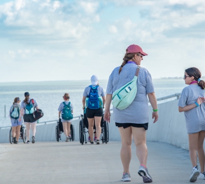Camps and partner staff walk and use wheelchairs to get across the foot bridge over FM 1781. Photo by: Beyond Memory Photography