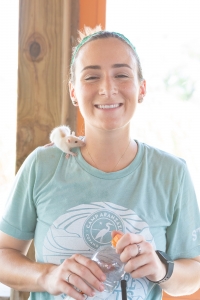 Amanda smiles with one of the Nature Hut rats on her shoulder