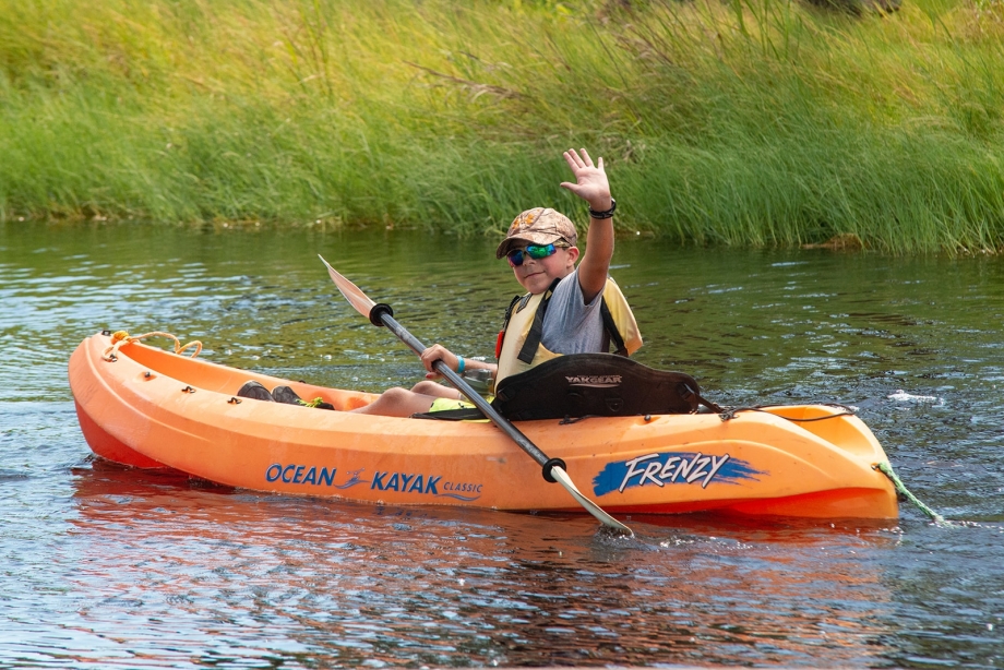 Camper from Camp MDA enjoying time kayaking in the Kayak Pond.