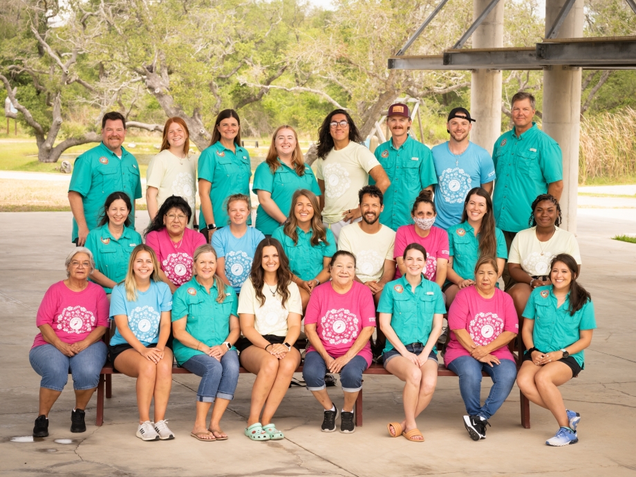 Full-time and seasonal staff smile for group picture at the plaza