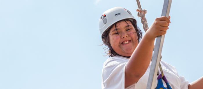 Child smiling during outdoor activity at special needs camp in Rockport, Texas.